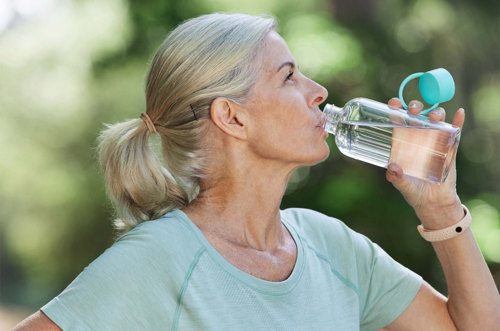 Blond Hair Woman Drinking from a Water Bottle
